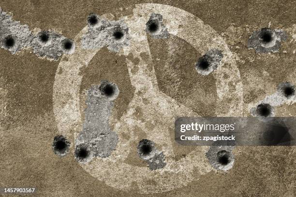 peace symbol on a wall with bullet holes - bullet marks stock pictures, royalty-free photos & images