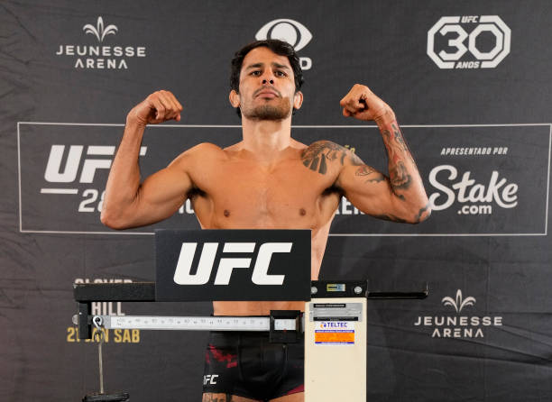 Alexandre Pantoja of Brazil poses on the scale during the UFC 283 official weigh-in at the Windsor Marapendi Hotel on January 20, 2023 in Rio de...