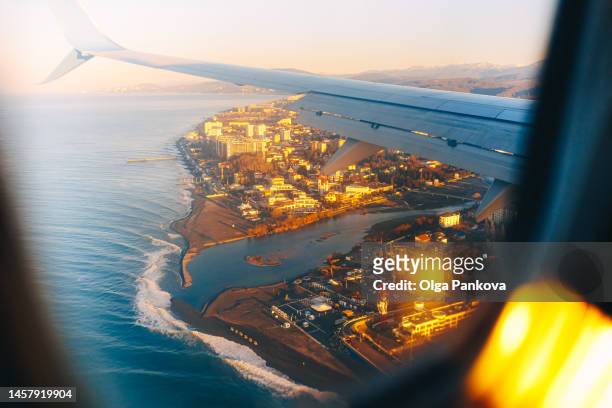 airplane window with a view of seashore and city - russian black sea stock pictures, royalty-free photos & images
