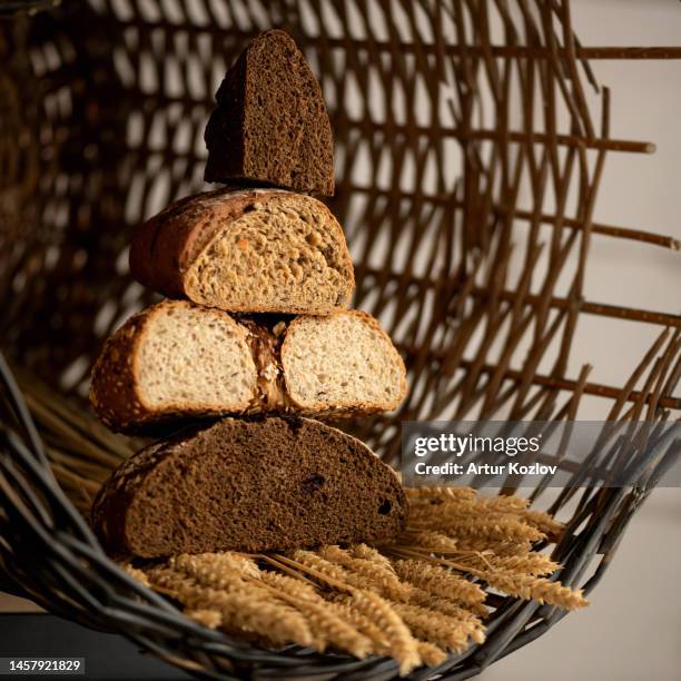 loaves of bread in cut on ears of wheat in trug. different types of bread in section. slide of different types of bread cut form - rhizopus stock pictures, royalty-free photos & images