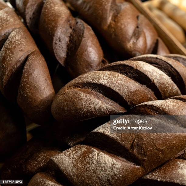 black rye long loaves of bread of oval form. freshly baked bread. leavened bread. close-up - rhizopus stock pictures, royalty-free photos & images