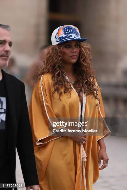Tyra Banks seen wearing an orange Kimono, black sneaker, colorful Louis Vuitton Cap outside the Louis Vuitton Show during Pariser Fashion Week on...