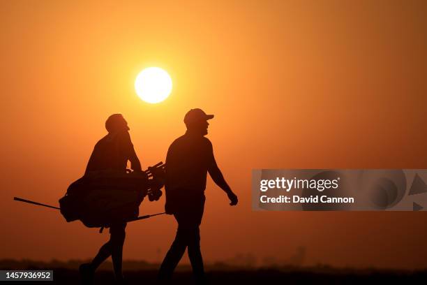 Richie Ramsay of Scotland walks to the green as the sun sets on the 18th hole during the second round on day two of the Abu Dhabi HSBC Championship...