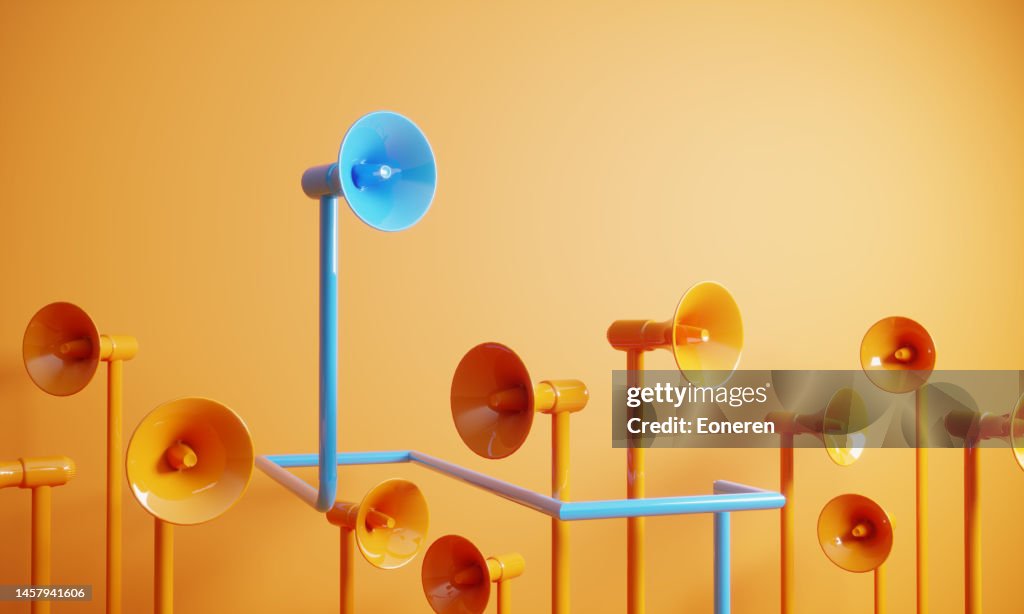 Blue colored megaphone standing out from the crowd