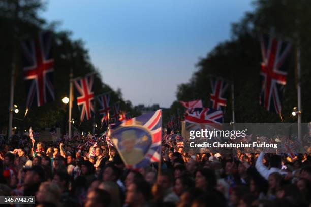 Reveller on the The Mall enjoy the festivities as thousands gather for The Diamond Jubilee Concert on June 4, 2012 in London, England. For only the...