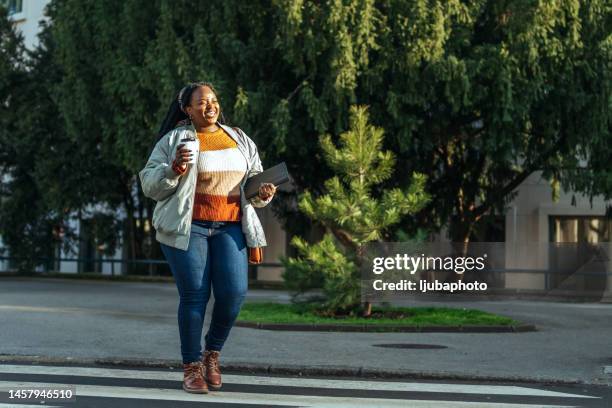 businesswoman walking on the street of modern city - big fat women stock pictures, royalty-free photos & images