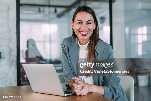 Successful businesswoman in modern office working on laptop. Successful businesswoman in modern office working on laptop.