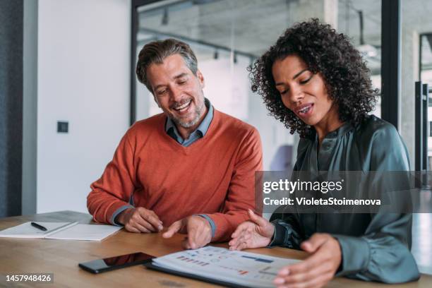 colleagues discussing project at workplace. - customer success stock pictures, royalty-free photos & images