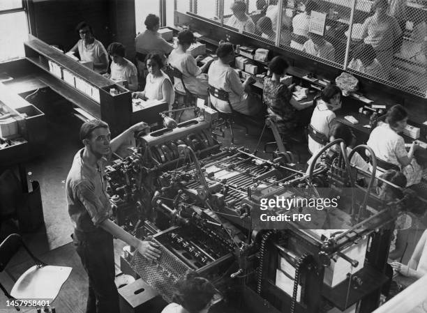 Bureau of Engraving and Printing employees, with a man at a printing press as well as women counting banknotes during production of smaller size...