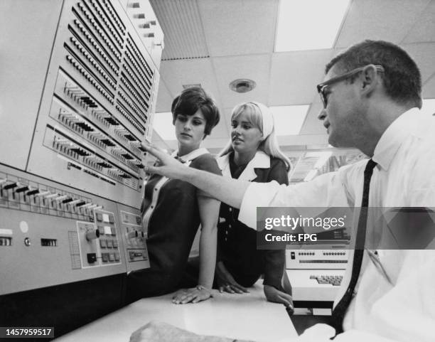 National Airlines Reservations Agents Nancy Chaffee and Sharon Frankau with IBM representative Robert Hanson as National Airlines' information center...