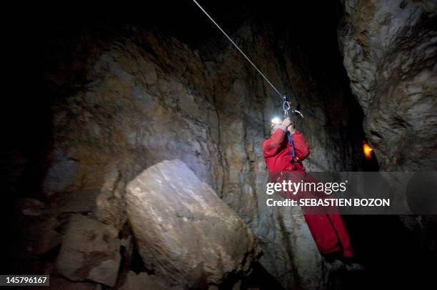 Speleologist of the Doubs Departmental Committee uses a so-called "Flying Fox" in the Cavottes' cave in Montrond-le-Château, eastern France, on June...