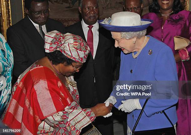 Queen Elizabeth II talks with President of Malawi Joyce Banda at a reception prior to a lunch with Commonwealth Nations Heads of Government on June...