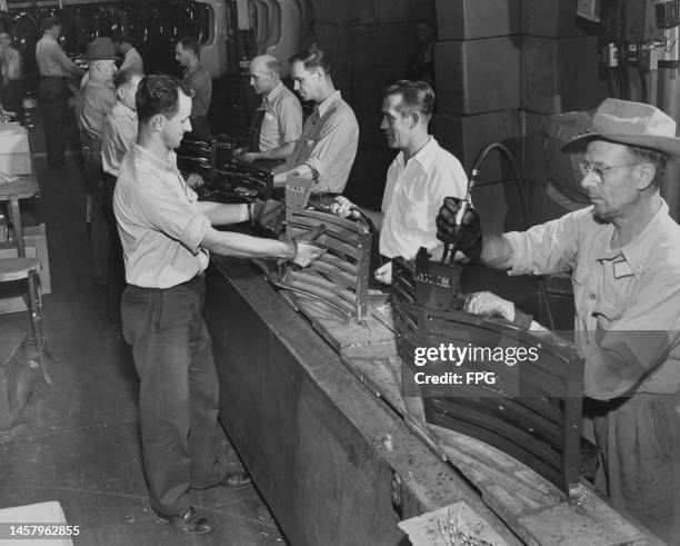 Chrysler workers assembling grilles for 1947 Plymouth automobiles at the Chrysler assembly plant in Detroit, Michigan, circa 1947.