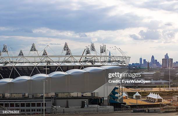 Dark clouds in the sky over the new Water Polo Arena and Olympic Stadion in the Olympic Park and skyline of the city on April 15, 2012 in London,...