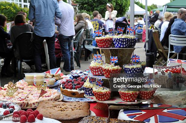 Foreground display of patriotic and royally themed homemade cakes to be consumed by the residents of Melbourne Road, Wimbledon, South West London...