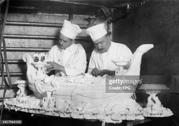 Louis Paquet, Head Chef of the Hotel McAlpin, assisted by Louis Canale prepare a Venetian Gondola to be exhibited at the National Hotel Exposition,...