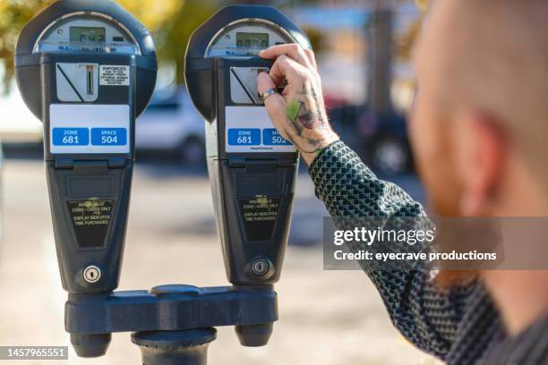 adult male in wheelchair using parking meter on small town western usa city street in autumn photo series - happiness meter stock pictures, royalty-free photos & images