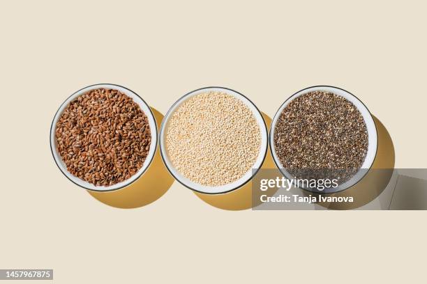 assortment of seeds, healthy food ingredients, superfood. flat lay, top view, copy space. chia, flax seeds, white sesame seeds on beige background. - flax seed stock pictures, royalty-free photos & images