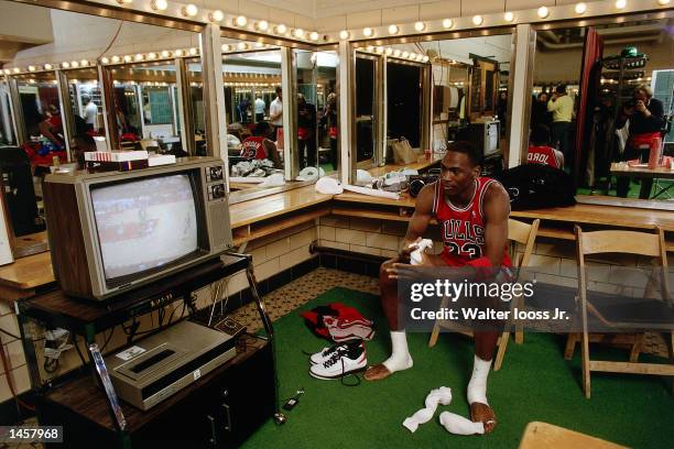 Michael Jordan of the Chicago Bulls watches video tape prior to playing the Milwaukee Bucks in 1988 during a NBA game at The Bradley Center in...