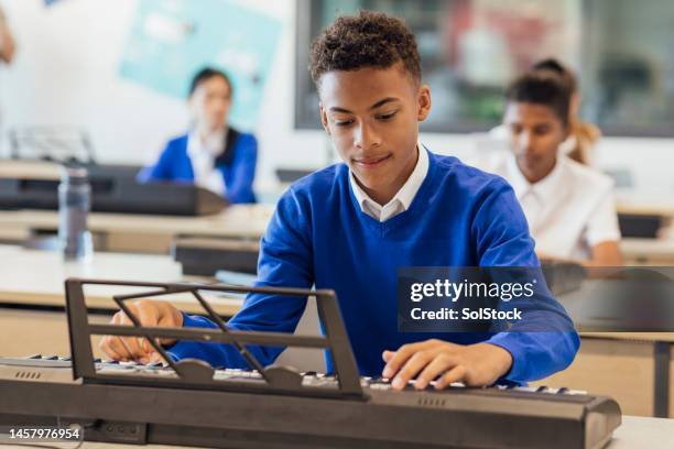 teenage boy playing keyboard - secondary school uniform stock pictures, royalty-free photos & images