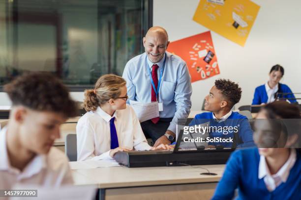 following the teacher's instructions - male teacher in a classroom stock pictures, royalty-free photos & images