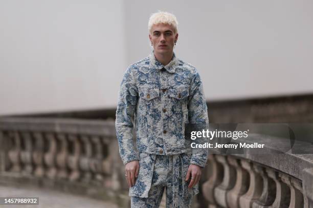 Fashion Week Guest seen wearing full Louis Vuitton Look, blue beige suit and black Louis Vuitton bootwearing outside the Louis Vuitton Show during...