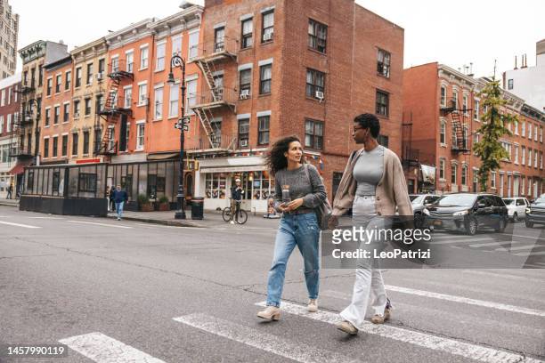 friends walking in the west village, ny - new york tourist stockfoto's en -beelden