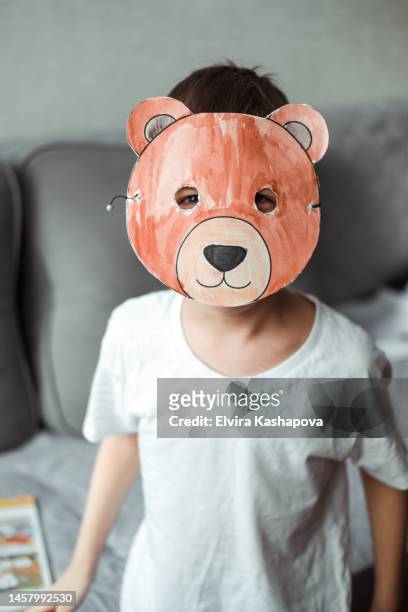 the boy made a paper bear mask and put it on. diy paper craft - homemade mask stock pictures, royalty-free photos & images