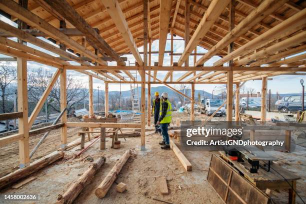 construction workers in building site. - timber frame home stock pictures, royalty-free photos & images