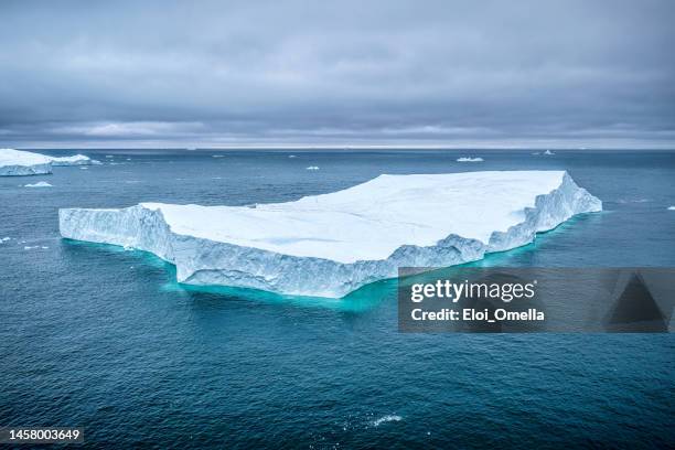 aerial view of icebergs floating in the arctic sea, greenland - ice-floe stock pictures, royalty-free photos & images