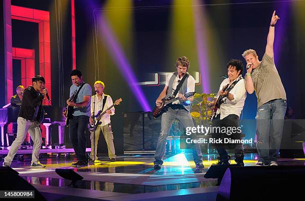 Journey members Arnel Pineda, Ross Valory , and Neal Schon and Rascal Flatts members Jay DeMarcus , Joe Don Rooney , and Gary LeVox perform onstage...