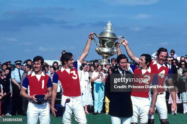 Prince Charles, Prince of Wales poses with members of the Rest of the World polo team, including Mexican player Antonio Herrera , as they raise the...