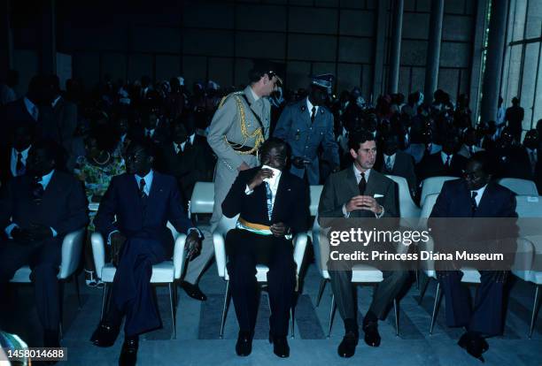 Prince Charles, Prince of Wales sits with various dignitaries, including Abidjan mayor Antoine Konan Kanga and Ivorian politician Philippe Yace ,...