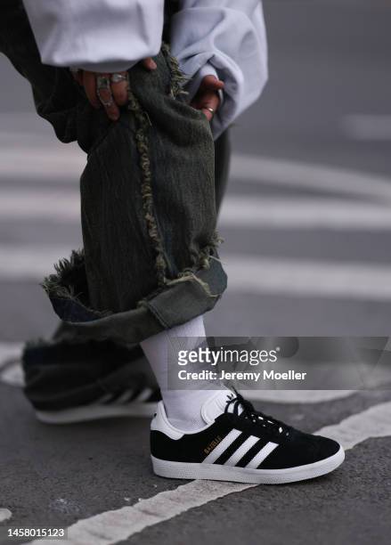 Dani Verdari seen wearing black Adidas gazelle sneaker, white socks, blau / green wide jeans trousers before the William Fan show during the Berlin...