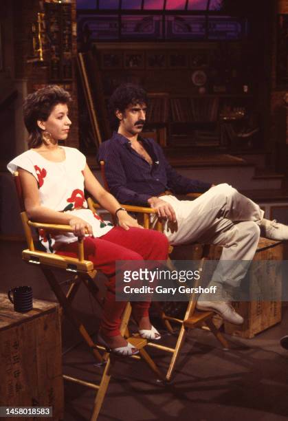 American actress and singer Moon Unit Zappa and her father, musician Frank Zappa sit in director's chairs during an interview on MTV at Teletronic...