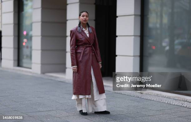 Shaquille Shaniqua Joy seen wearing black Adidas gazelle sneaker, red long leather coat, beige blouse, beige wide trousers before the William Fan...