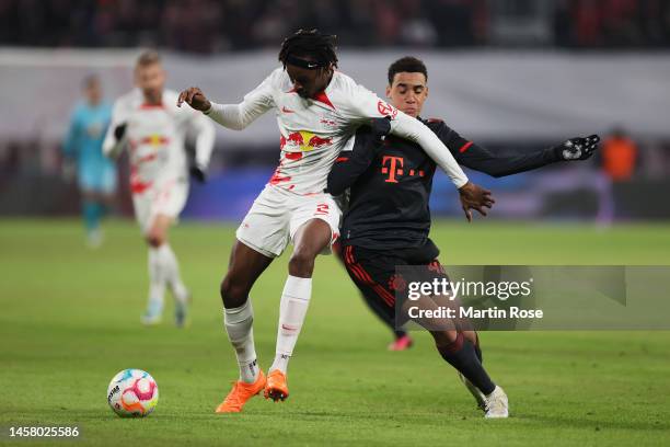 Mohamed Simakan of RB Leipzig battles for the ball with Jamal Musiala of Bayern Munich during the Bundesliga match between RB Leipzig and FC Bayern...