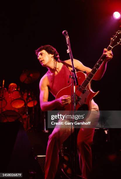 Australian-American Pop musician and actor Rick Springfield plays electric guitar as he performs onstage, with his band, at the Capitol Theatre,...