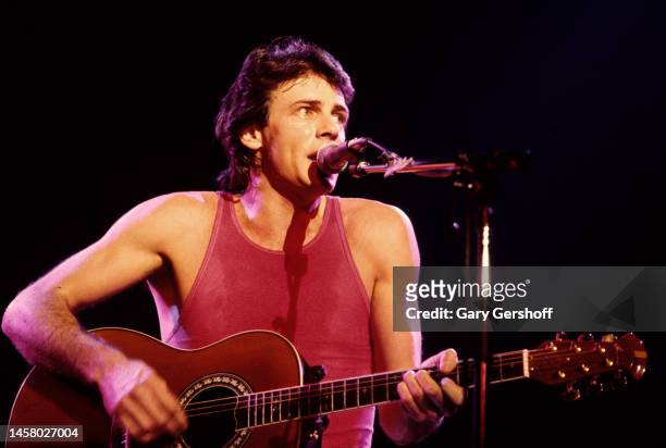 Australian-American Pop musician and actor Rick Springfield plays acoustic guitar as he performs onstage at the Capitol Theatre, Passaic, New Jersey,...