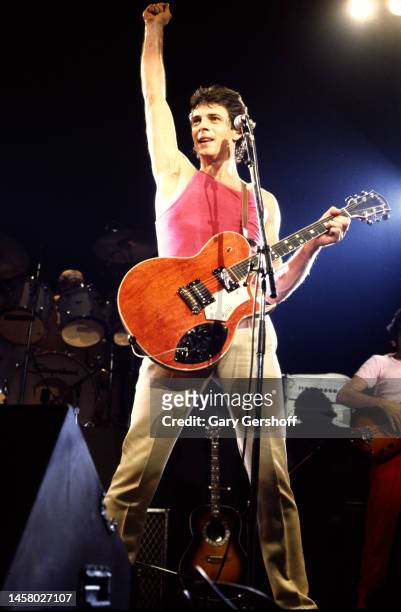 Australian-American Pop musician and actor Rick Springfield plays a Gretsch Super Axe electric guitar as he performs onstage, with his band, at the...