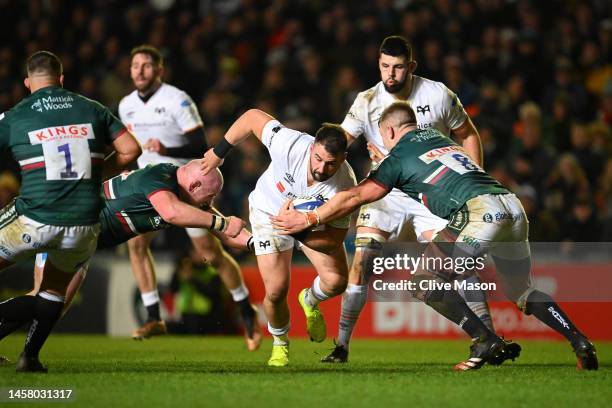 Scott Baldwin of Ospreys is tackled by Dan Cole and Olly Cracknell of Leicester Tigers during the Heineken Champions Cup Pool B match between...