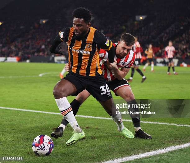 Benjamin Tetteh of Hull City battles for possession with Jack Robinson of Sheffield United during the Sky Bet Championship match between Sheffield...
