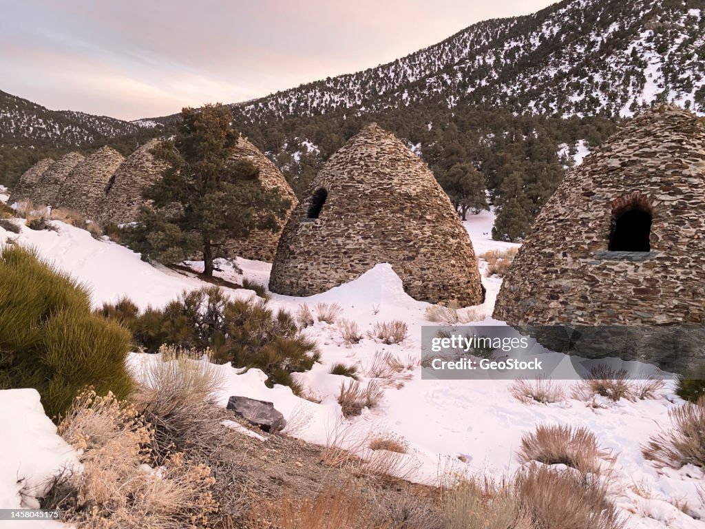 Beehive stone kilns in a wintry landscape
