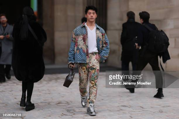 Fashion Week Guest seen wearing full Louis Vuitton Look, Louis Vuitton Denim Jeans flower pattern jacket and matchy pants, white pullover and a brown...