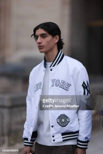 Fashion Week Guest seen wearing full Louis Vuitton Look, white New York jacket, white sweater and brown pants, outside the Louis Vuitton Show during...