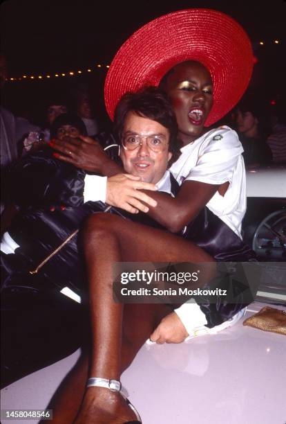 Jamaican-born singer and model Grace Jones embraces producer Allan Carr at 'Grease' premiere party at Studio 54, New York, New York, June 13, 1978.