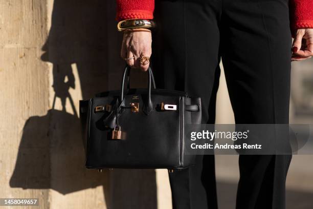 Petra Dieners wears a red Celine jacket, black and white blouse by Celine, Orwell trousers, YSL shoes, Projekt Produkt sunglasses, bracelet by...