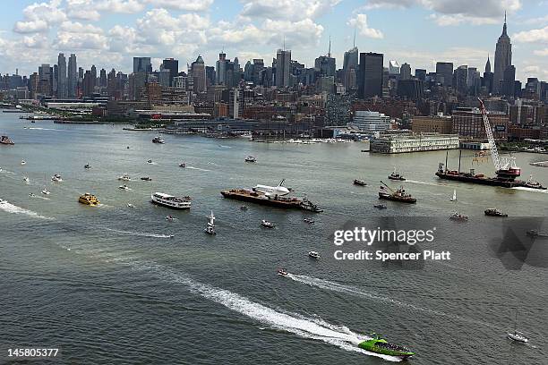 Flotilla surrounds NASA space shuttle Enterprise as it is carried by barge up the Hudson River on route to its permanent home at the Intrepid Sea,...