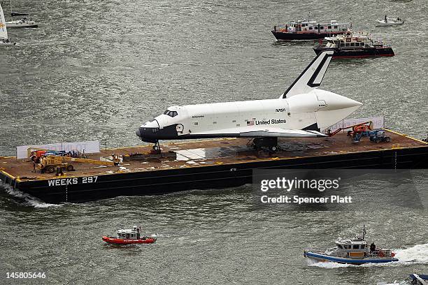 Flotilla surrounds NASA space shuttle Enterprise as it is carried by barge up the Hudson River on route to its permanent home at the Intrepid Sea,...