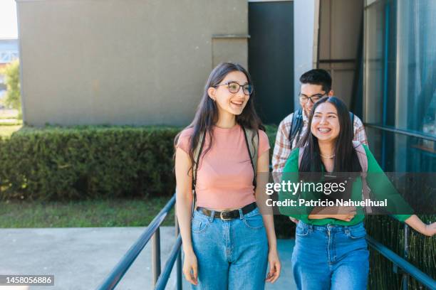 group of latin american university students walking through a ramp outside a classroom building in the campus. - chilean ethnicity stock pictures, royalty-free photos & images